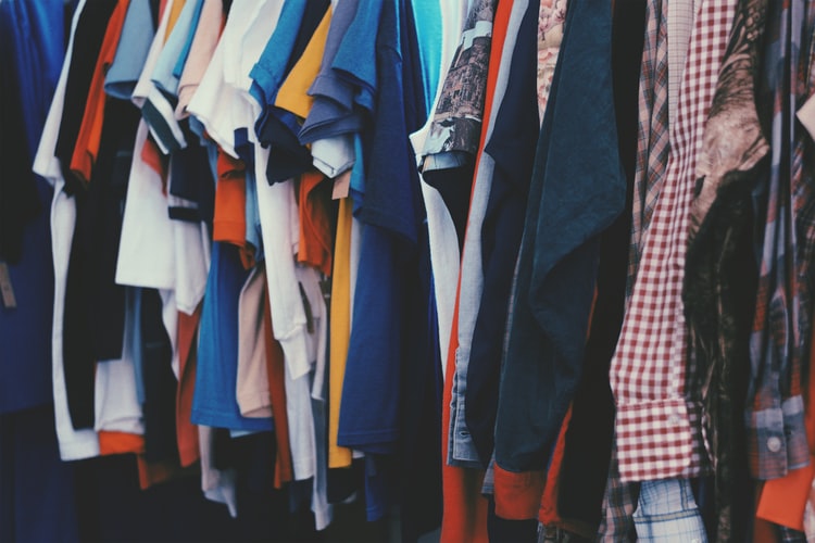 Custom t-shirts hanging in wardrobe